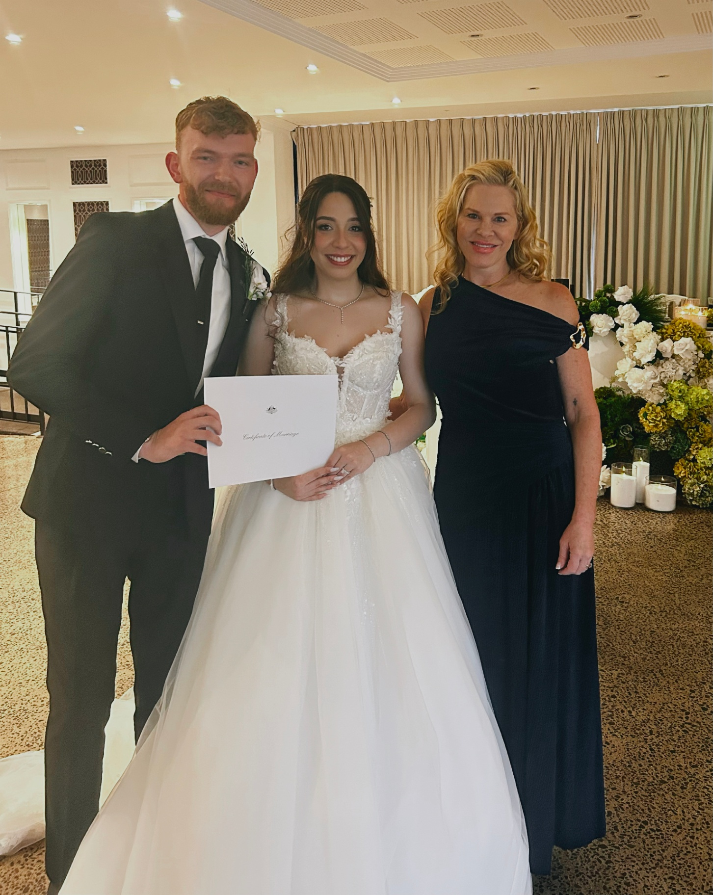Nicole with newlyweds after their indoor ceremony
