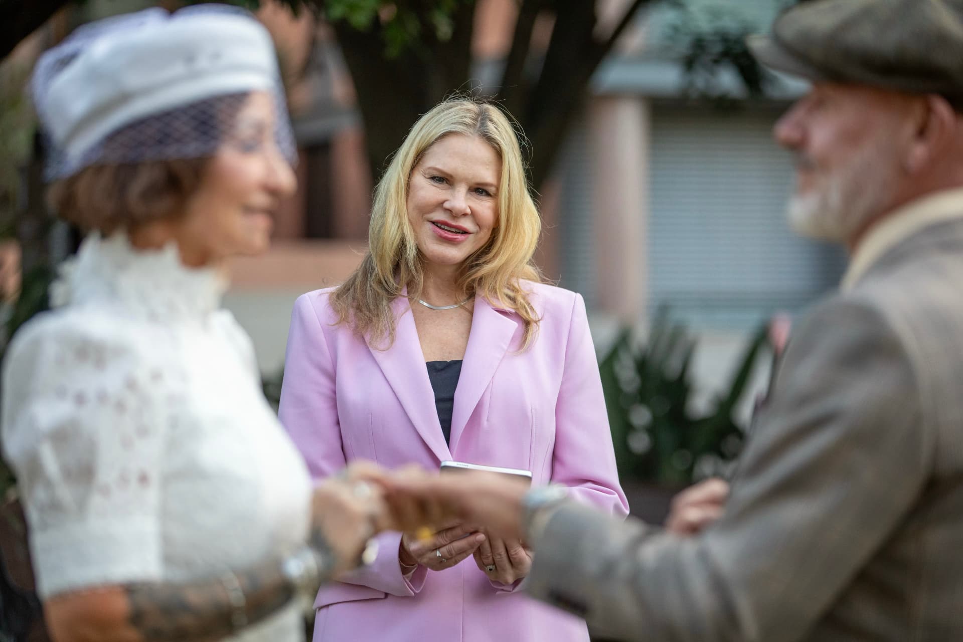 Nicole leading the vows at a garden ceremony