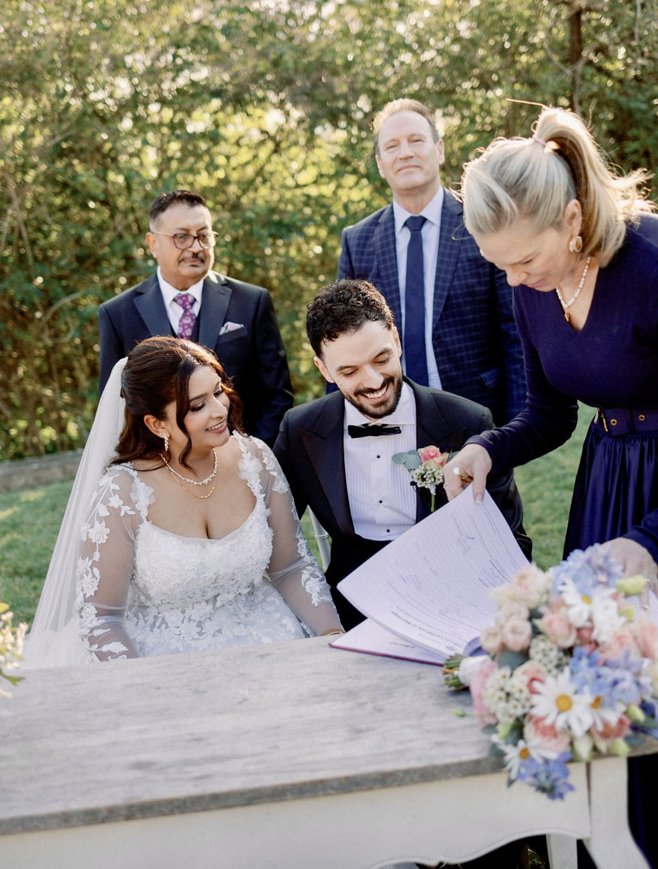 Signing the marriage register, family looking on