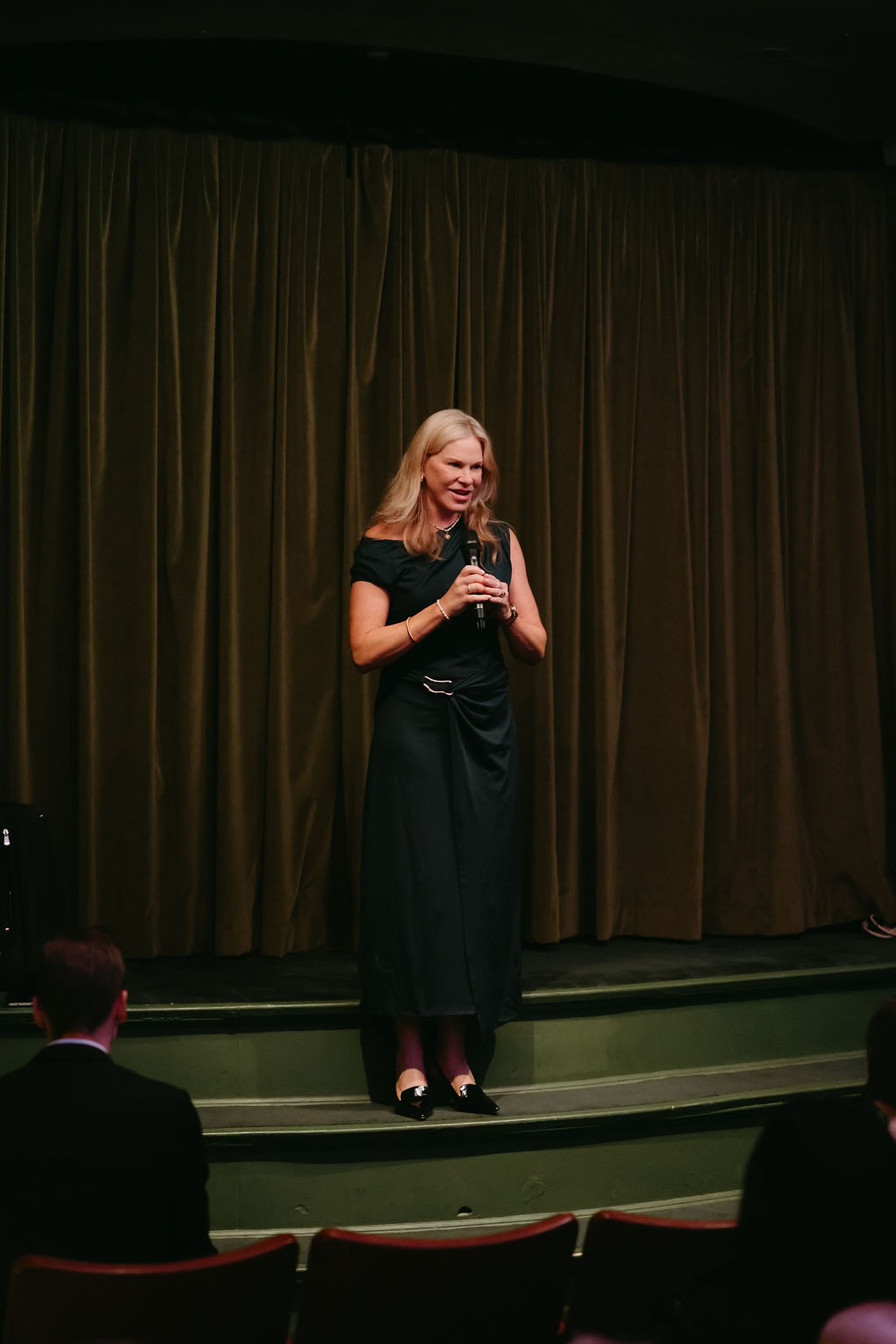 Nicole on stage, welcoming the guests