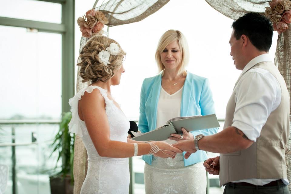 Holding hands through the vows, waterfront Sydney