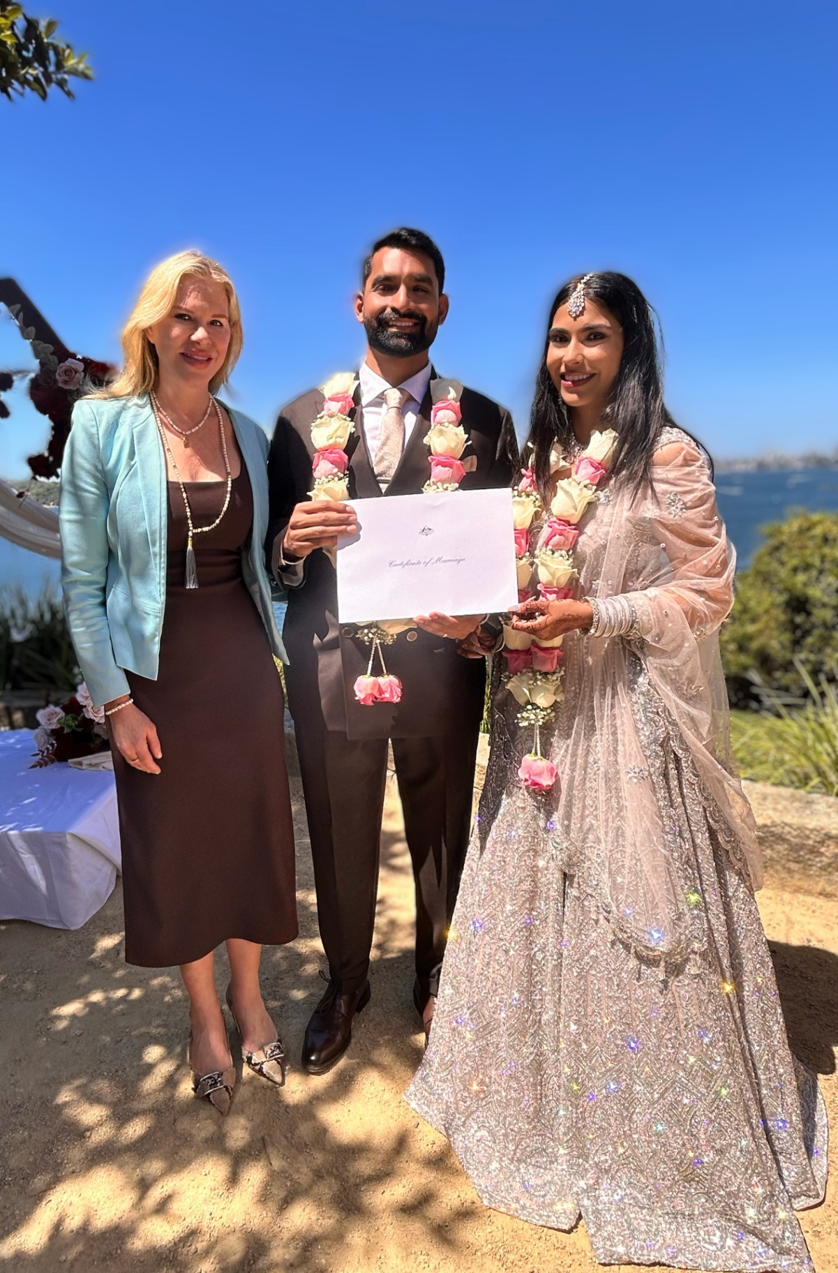 Nicole with newlyweds after their waterside cultural ceremony