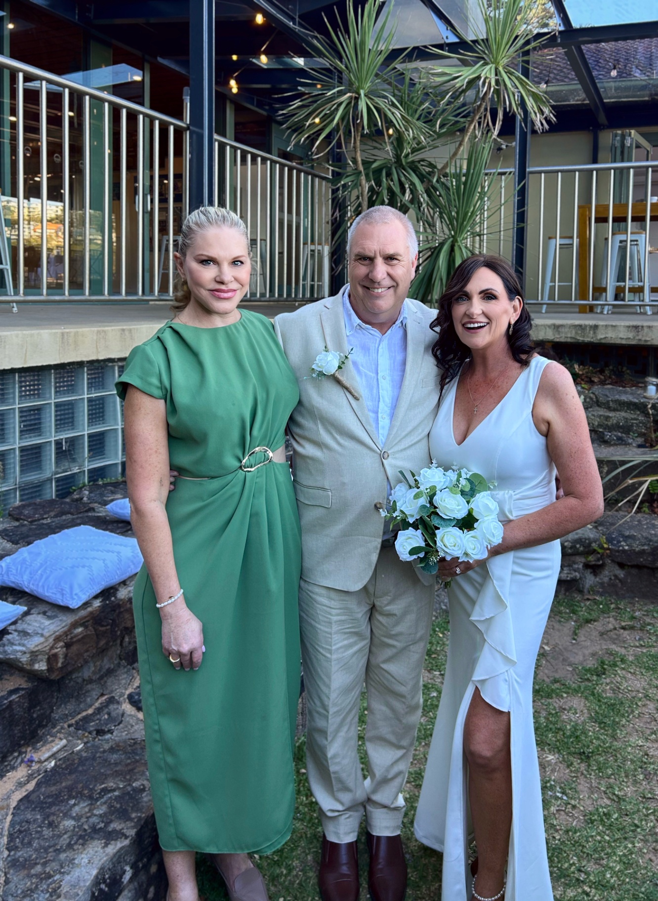 Nicole with newlyweds after an intimate garden ceremony